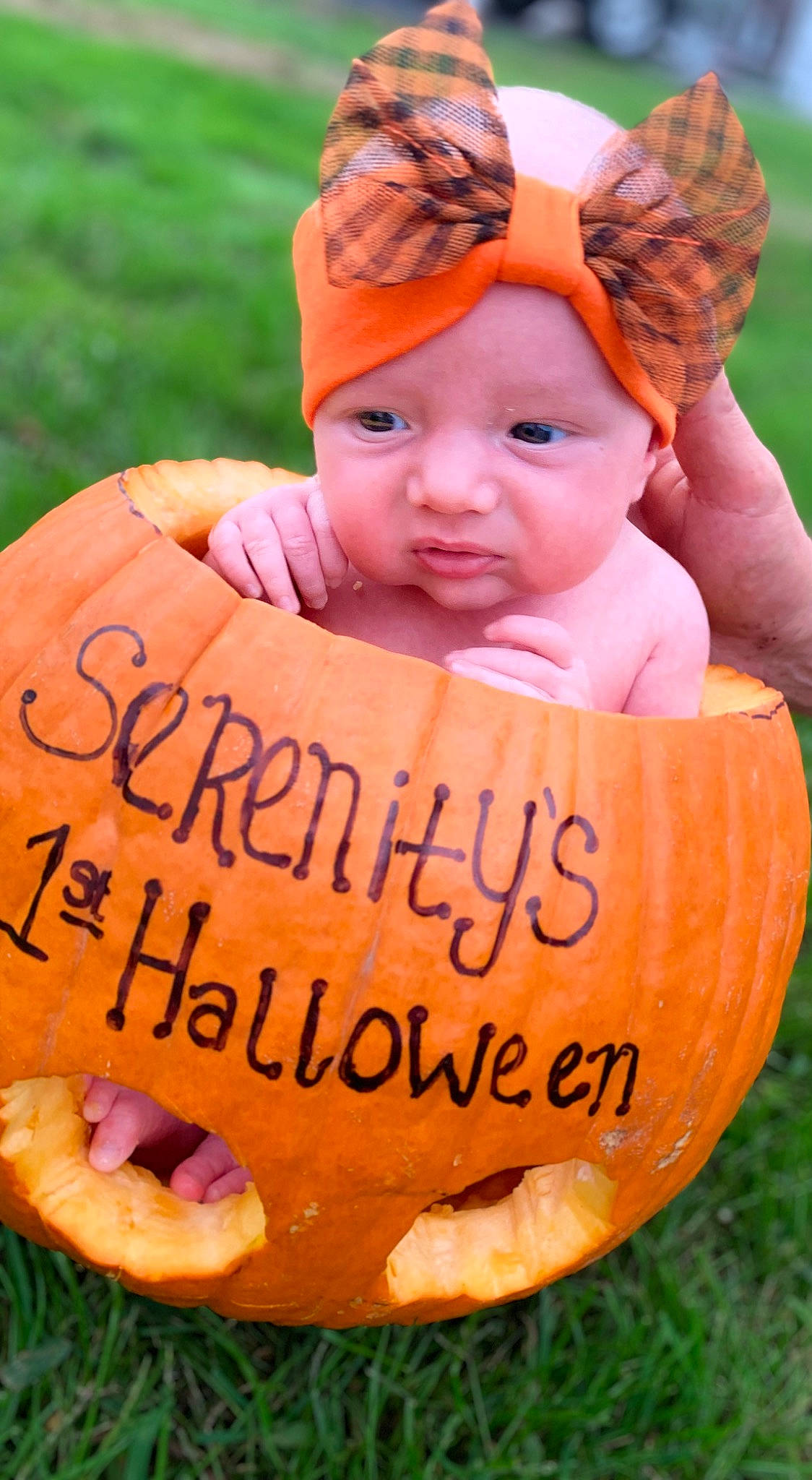 Serenity is registered to the contest to win money with this photo: baby, baby_toddler_clothing, calabaza, cap, cucurbita, eye, facial_expression, grass, happy, hat, headwear, human_body, leaf, natural_foods, orange, organ, people_in_nature, person, plant, pumpkin