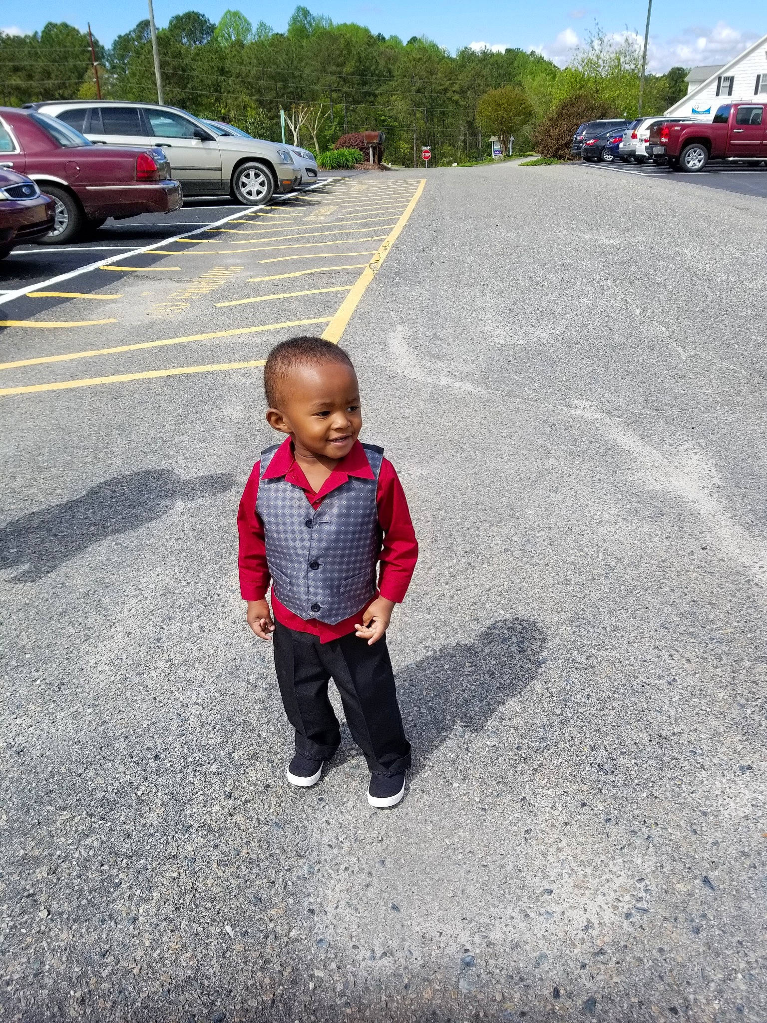 Tyriq is registered to the contest to win money with this photo: asphalt, car, child, compact_car, family_car, infrastructure, joy, lane, luxury_vehicle, person, plant, road, road_surface, toddler, tourism, vacation, vehicle, walking