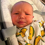 Marcus joined the competition — help win amazing prizes! baby, infant, face, blanket, taco_pattern, clothing, seat, straps, indoors, closeup, expression, cute, child, newborn, soft, comfort, head, skin, portrait, resting