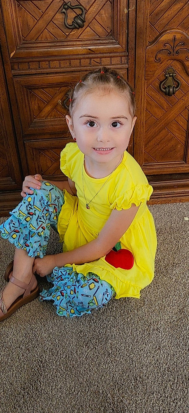 Sahara joined the competition — help win amazing prizes! baby, baby_toddler_clothing, cheek, child, dress, electric_blue, flooring, fun, happy, hardwood, human_leg, joy, pattern, person, play, sitting, sleeve, smile, t_shirt, toddler