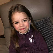 Neïla participe au concours pour gagner de l'argent avec cette photo : child, girl, smile, long_hair, jacket, purple, earrings, chair, cushion, indoor, portrait, happy, face, person, young, seated, cozy, casual, leather, zipper