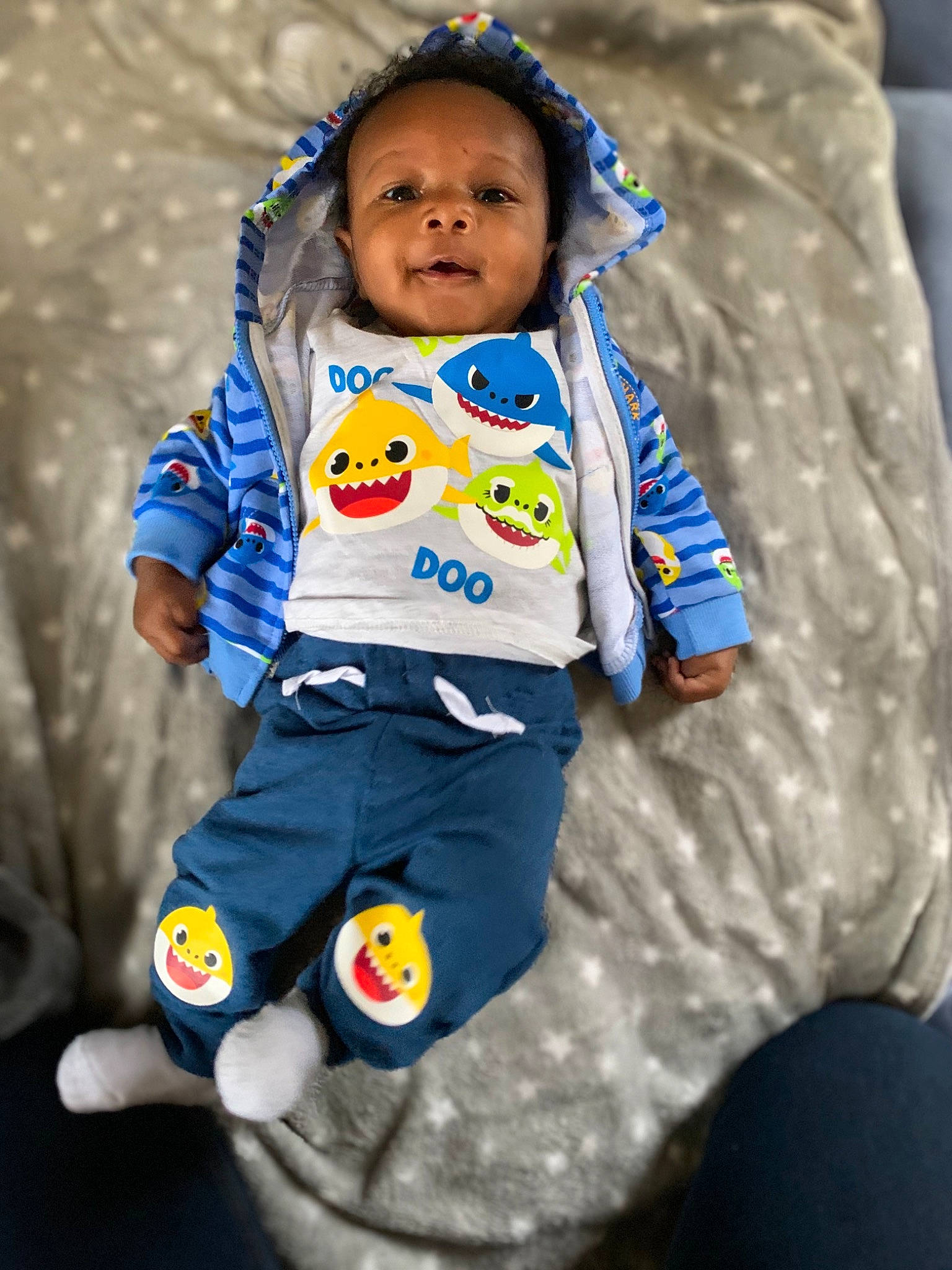 Xane is registered to the contest to win money with this photo: baby, baby_products, baby_toddler_clothing, blue, child, hood, overall, person, sleeve, sock, toddler
