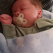 Kyron is registered to the contest to win money with this photo: baby, sleeping, pacifier, blanket, cozy, child, infant, soft, cute, peaceful, rest, nap, clothing, indoors, portrait, closeup, newborn, warm, comfort, peace