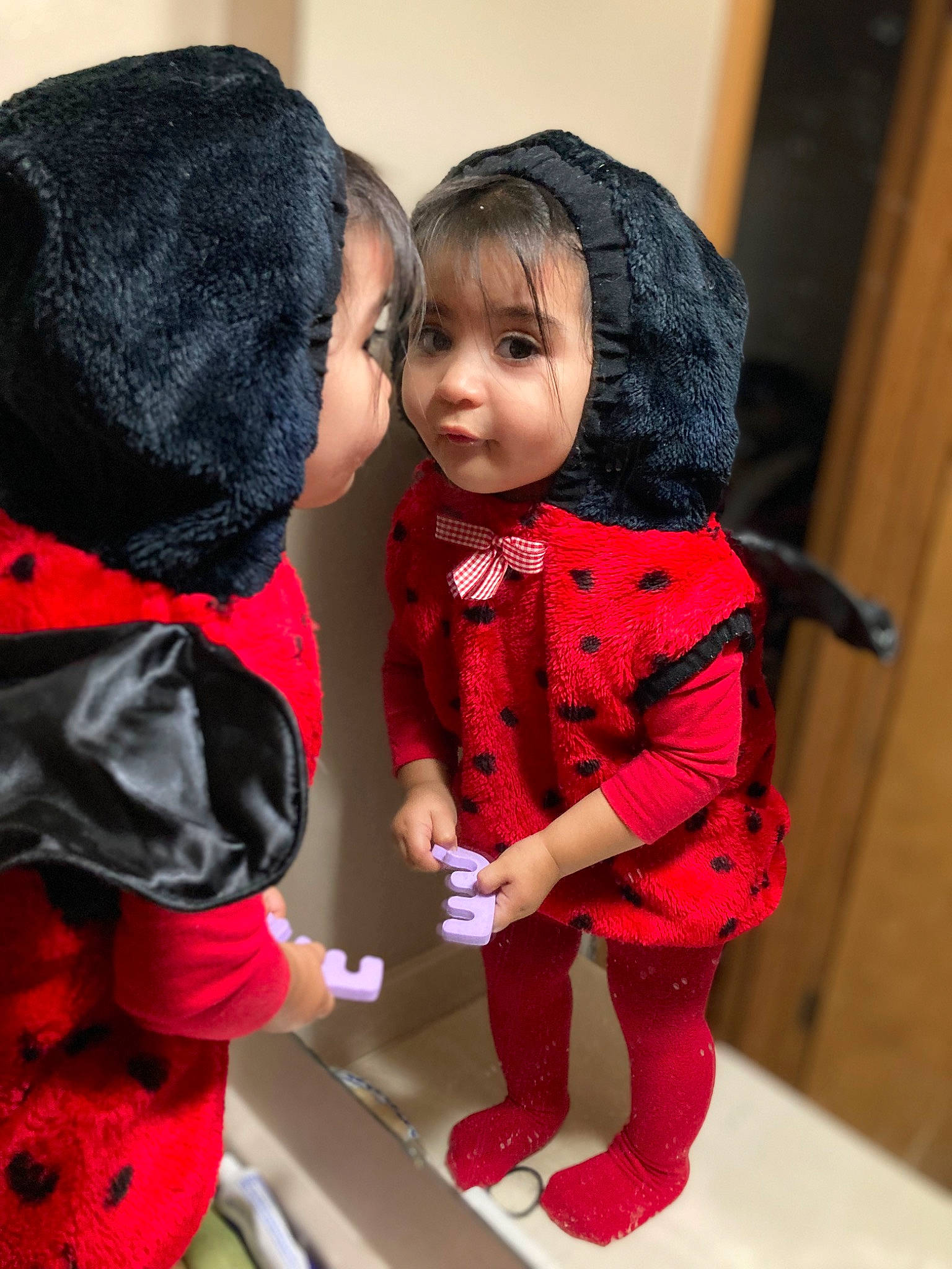 Luna is registered to the contest to win money with this photo: black_hair, cheek, child, costume, doll, eye, eyelash, fashion_accessory, fashion_design, fur, gesture, joint, lip, pattern, person, pink, red, skin, sleeve, toy