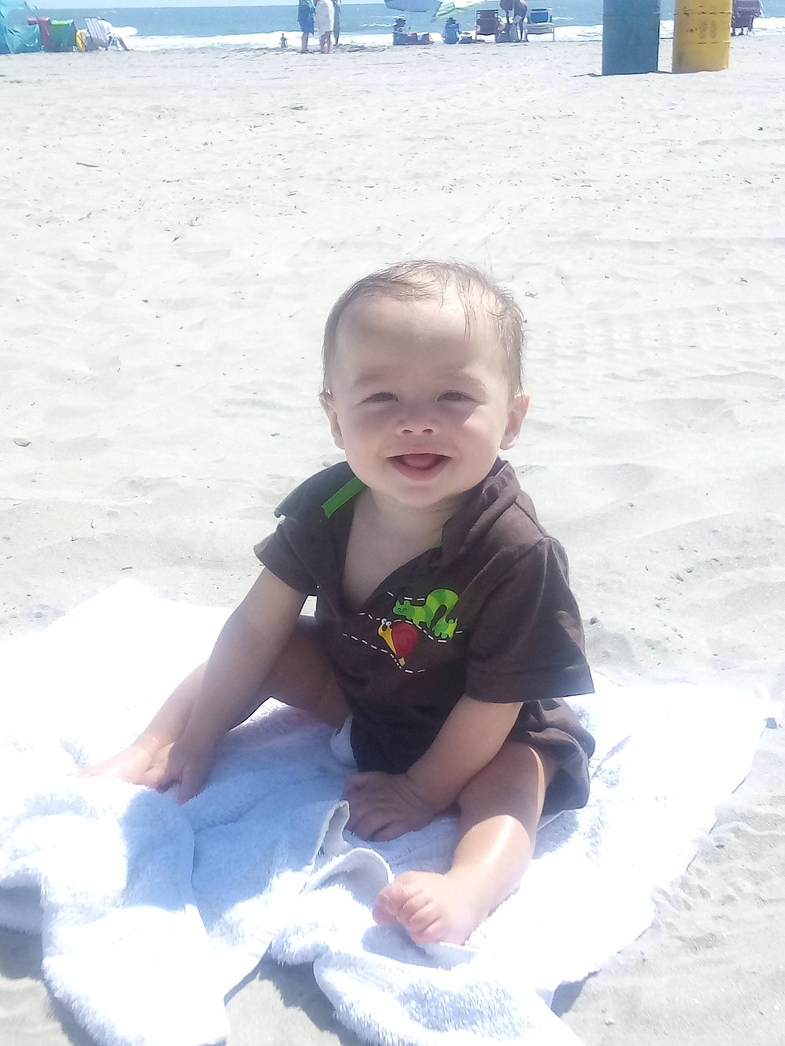 Micah is registered to the contest to win money with this photo: baby, baby_toddler_clothing, beach, beauty, blue, body_of_water, child, fun, happy, joy, leisure, people_on_beach, person, photograph, sky, smile, snapshot, summer, toddler, travel