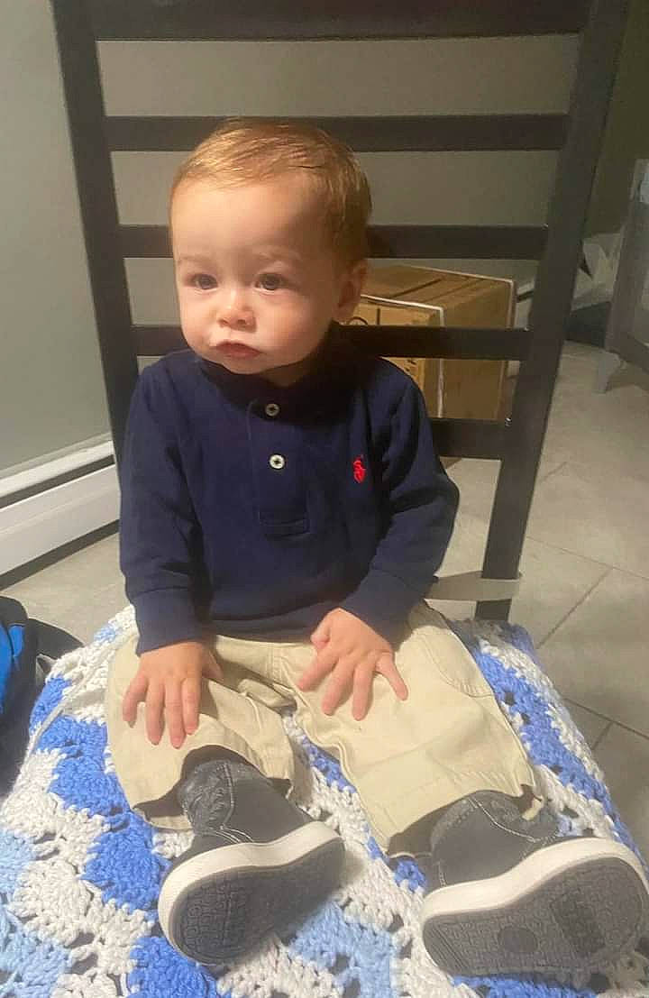Micah is registered to the contest to win money with this photo: baby, baby_toddler_clothing, child, electric_blue, floor, flooring, fun, hardwood, luggage_and_bags, person, plastic, play, room, sitting, sleeve, t_shirt, toddler, walking_shoe, wood