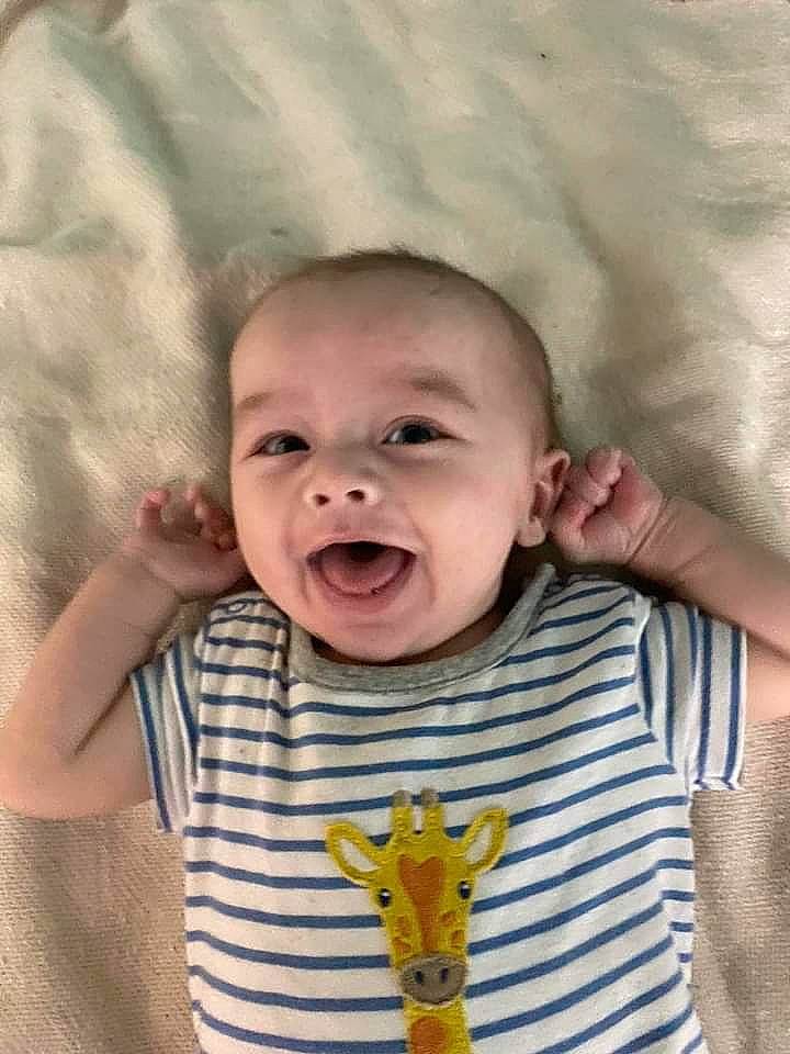 Micah is registered to the contest to win money with this photo: baby, baby_toddler_clothing, cheek, chin, comfort, eye, face, finger, gesture, happy, head, iris, mouth, nose, person, skin, sleeve, smile, t_shirt, toddler