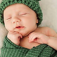 Eryk is registered to the contest to win money with this photo: baby, blanket, child, closeup, cozy, cute, green_hat, hand, headwear, indoors, infant, knitted_hat, newborn, peaceful, portrait, resting, skin, sleeping, soft, wrapped