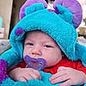 baby, infant, pacifier, costume, blue, purple, red_clothing, sleepy, tired, face, hand, cute, soft_texture, plush, child, indoors, portrait, closeup, young, babywear