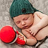 baby, blanket, button, child, comfort, cozy, cute, hand, hat, indoors, infant, knit, peaceful, portrait, red_toy, resting, skin, sleeping, soft_texture, warm