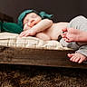 Eryk is registered to the contest to win money with this photo: baby, child, closeup, cozy, cushion, cute, feet, gray_pants, green_hat, indoors, infant, peaceful, pillow, portrait, relaxation, resting, sleeping, soft_texture, toes, wooden_bed