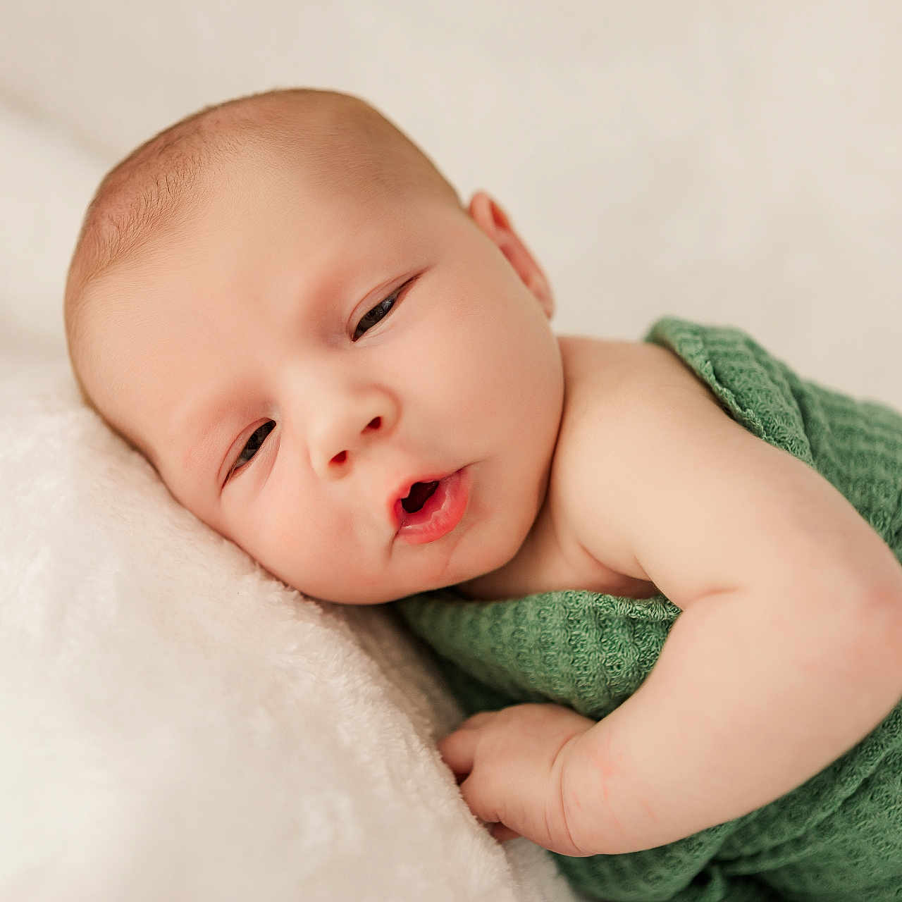 Eryk is registered to the contest to win money with this photo: baby, blanket, child, closeup, cute, expression, face, green, head, indoors, infant, lying_down, newborn, peaceful, portrait, resting, skin, sleepy, soft, wrapped