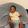 Rashad Sybren joined the competition — help win amazing prizes! baby, infant, smiling, happy, child, cushion, plush, indoor, clothing, shorts, shirt, person, seated, joyful, cute, skin, face, head, furniture, cozy