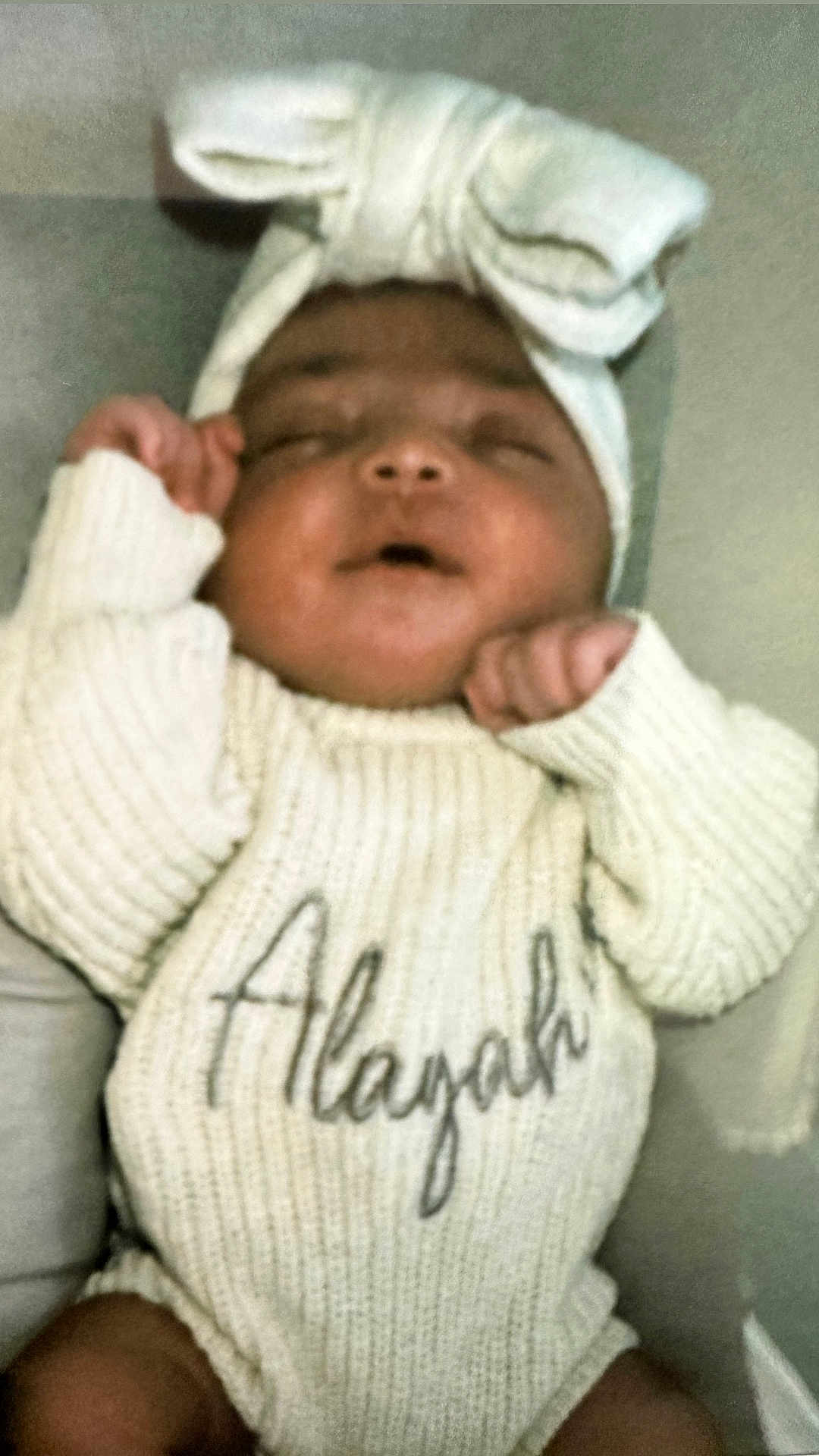 Alayah-Leigh joined the competition — help win amazing prizes! baby, infant, knitted_sweater, headband, bow, sleeping, peaceful, cute, child, portrait, soft_lighting, indoors, closeup, hands, face, young_child, warm_clothing, cozy, resting, newborn