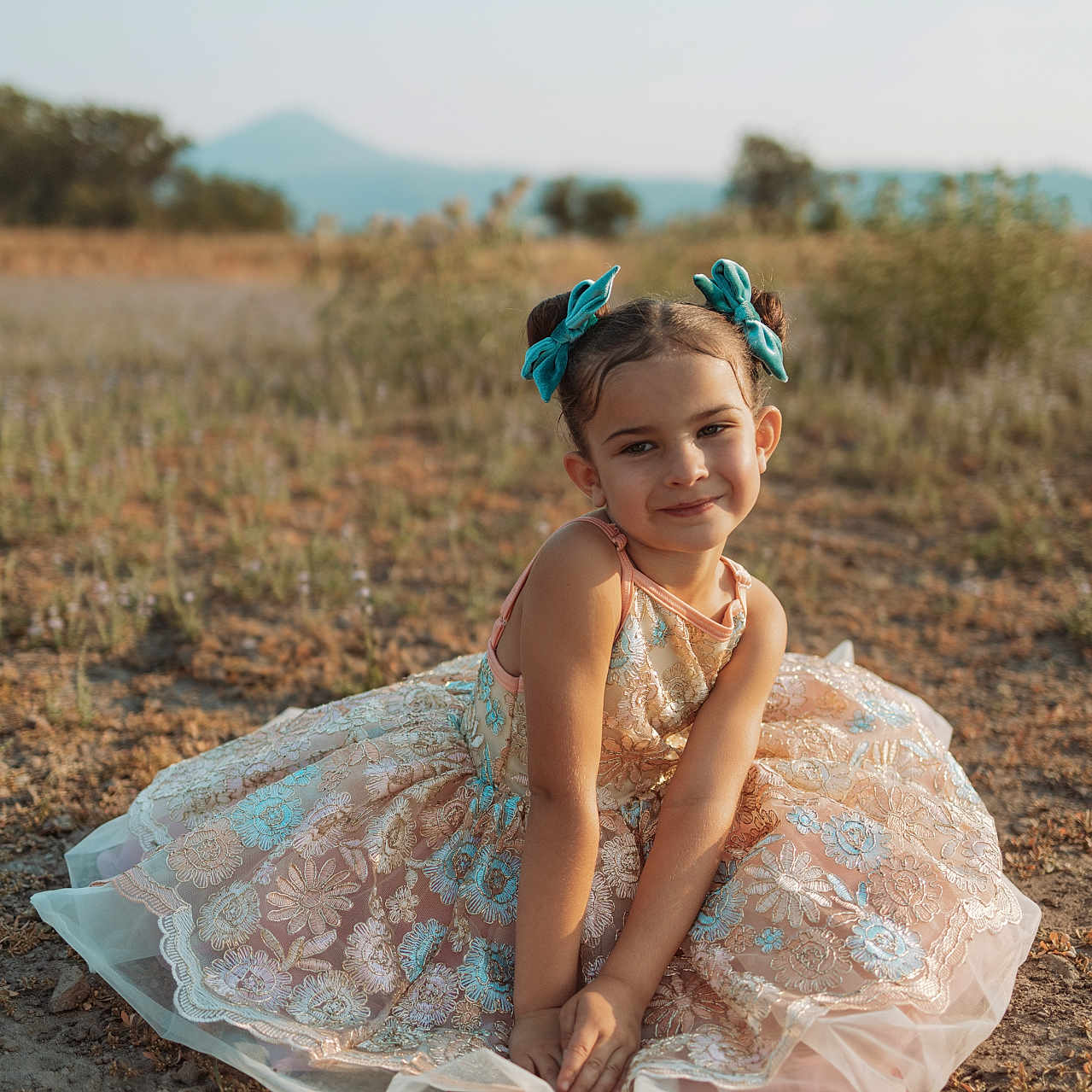 Ocean is registered to the contest to win money with this photo: beachwear, child, clothing, dress, eveningdress, face, fashion, female, formalwear, girl, gown, happy, head, laughing, person, photography, portrait, sitting, smile, soil