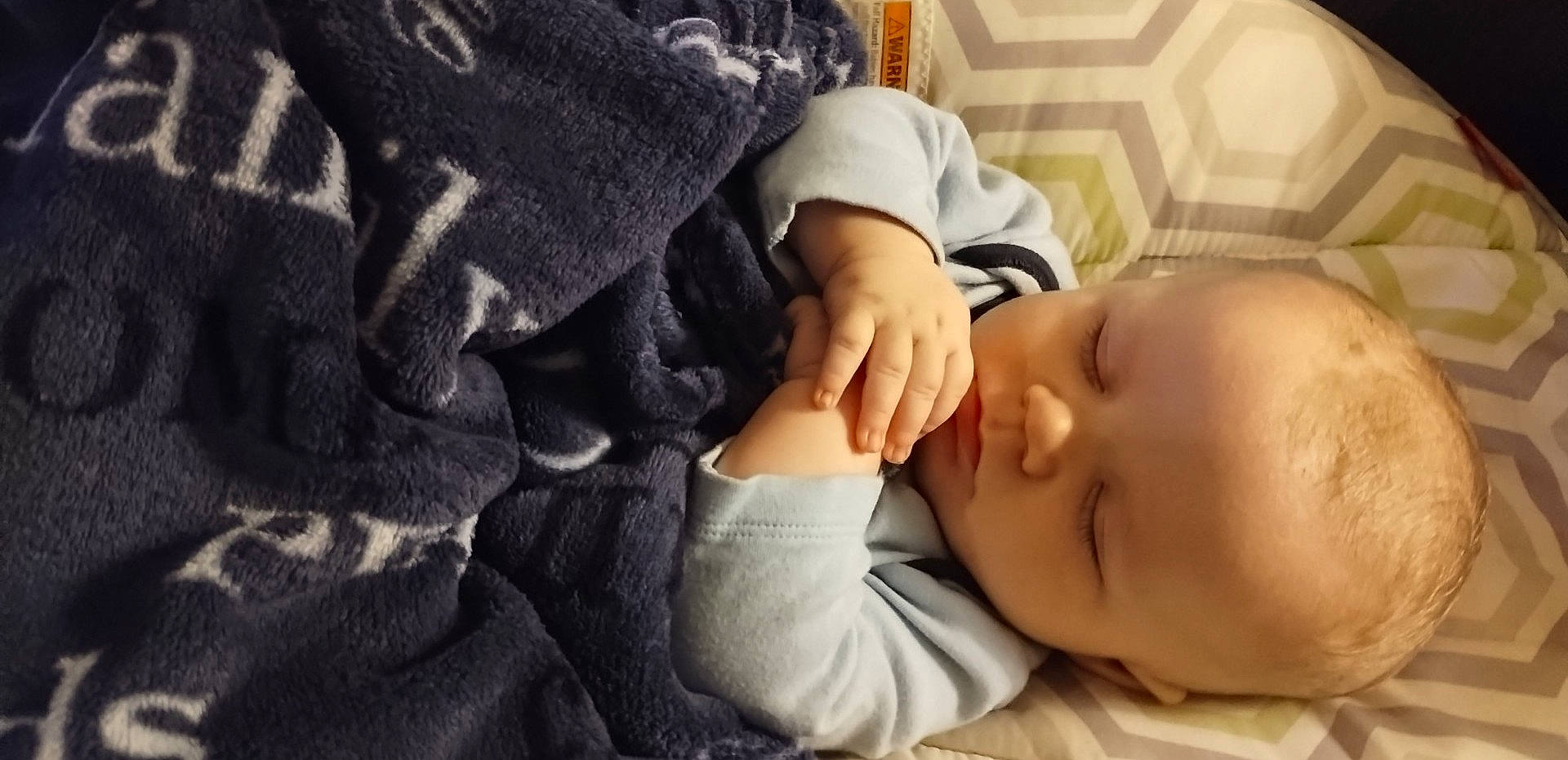 Lincoln joined the competition — help win amazing prizes! arm, baby, baby_sleeping, baby_toddler_clothing, cheek, child, comfort, eyelash, finger, gesture, hand, linens, nail, nap, person, sitting, skin, sleeve, thumb, toddler
