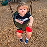 Anthony is registered to the contest to win money with this photo: toddler, child, swing, playground, outdoor, wood_chips, slide, climbing_structure, trees, daylight, shorts, shirt, footwear, curious, baby, park, play_equipment, person, seat, nature