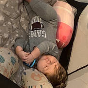Anthony is registered to the contest to win money with this photo: toddler, sleeping, playpen, pillow, blanket, toy, infant, child, cozy, indoor, clothing, gray_onesie, peaceful, nap, bedtime, soft, cute, resting, baby, comfort