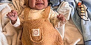 Ezekiel is registered to the contest to win money with this photo: baby, infant, smiling, blanket, beanie, hat, teddy_outfit, plush_overall, onesie, cozy, lying_down, bed, bedding, soft_texture, cute, portrait, hands_up, happy, nursery, grin