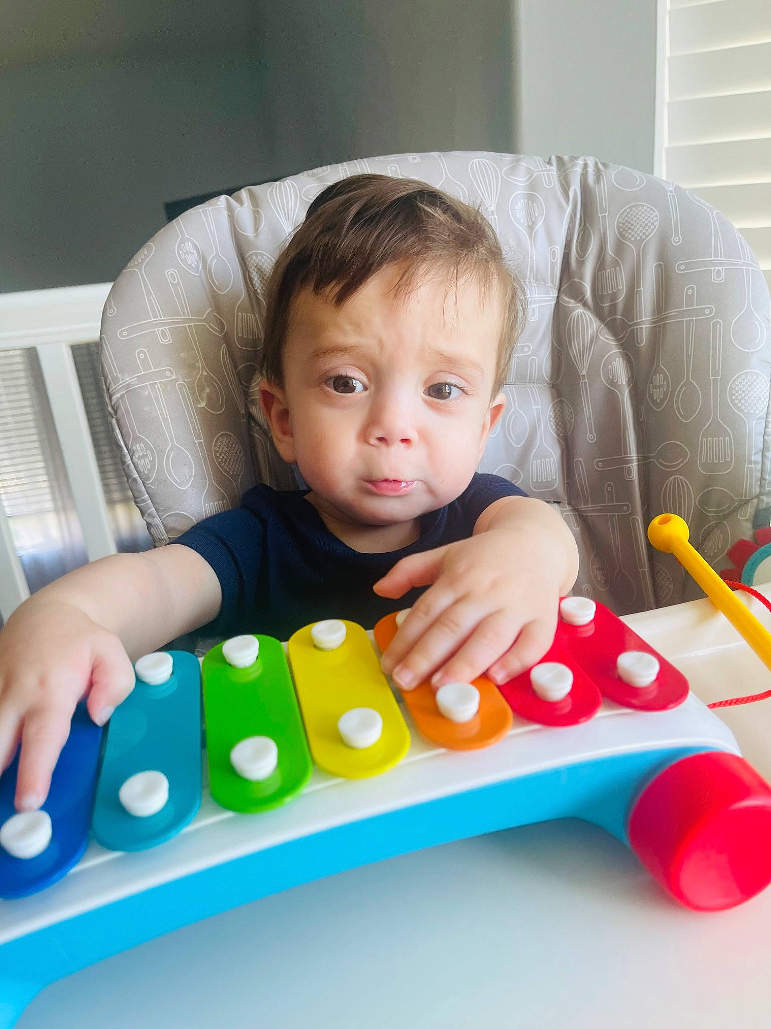 Hayes is registered to the contest to win money with this photo: baby, baby_playing_with_toys, baby_products, baby_toddler_clothing, baby_toys, chair, child, educational_toy, fun, person, plastic, play, recreation, rectangle, room, sitting, t_shirt, toddler, toy, window_blind