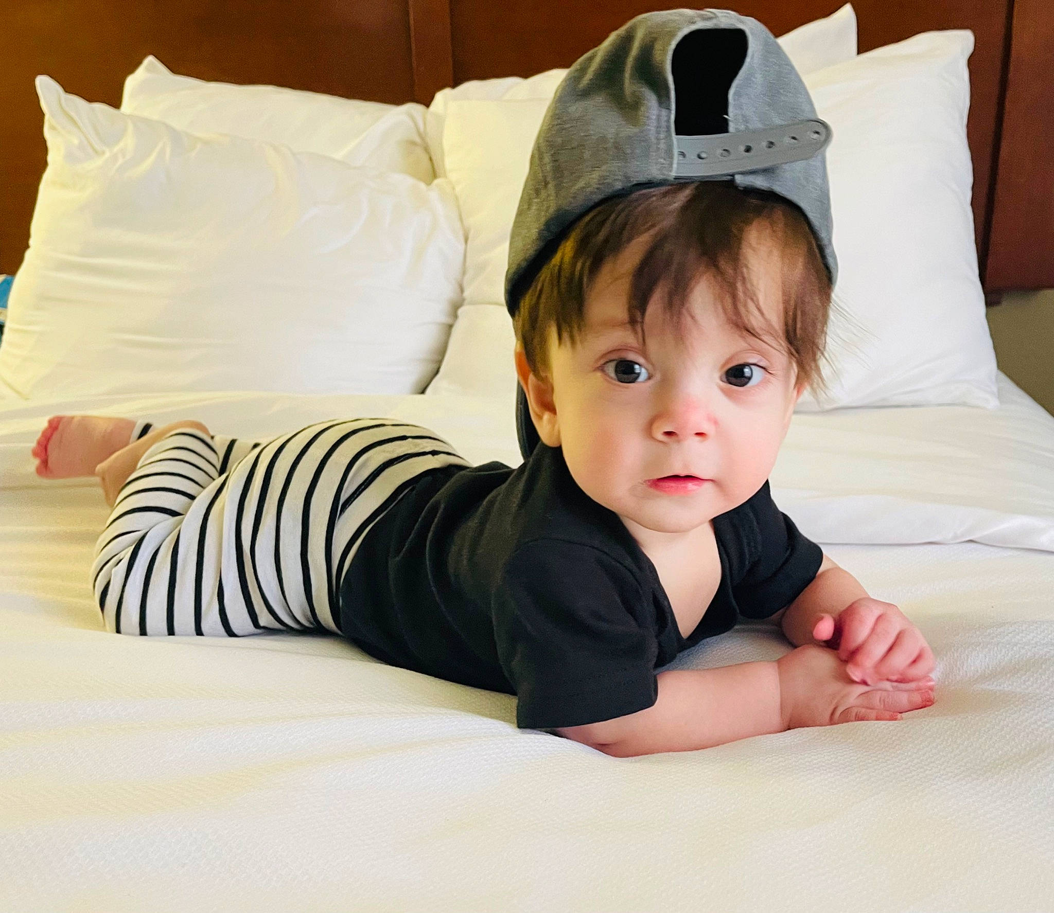 Hayes is registered to the contest to win money with this photo: baby, baby_toddler_clothing, child, comfort, eye, finger, flash_photography, flooring, happy, human_leg, linens, pattern, person, product, room, sitting, sleeve, t_shirt, textile, toddler