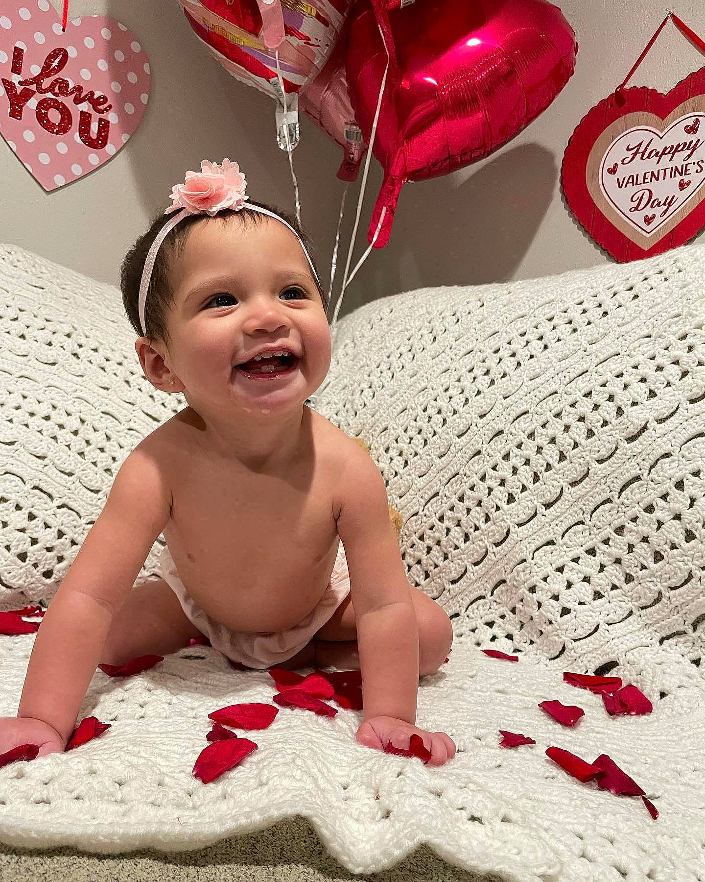 Kamila is registered to the contest to win money with this photo: baby, baby_toddler_clothing, cap, child, event, face, facial_expression, flooring, fun, happy, headpiece, human, joy, magenta, party_supply, person, petal, pink, red, smile