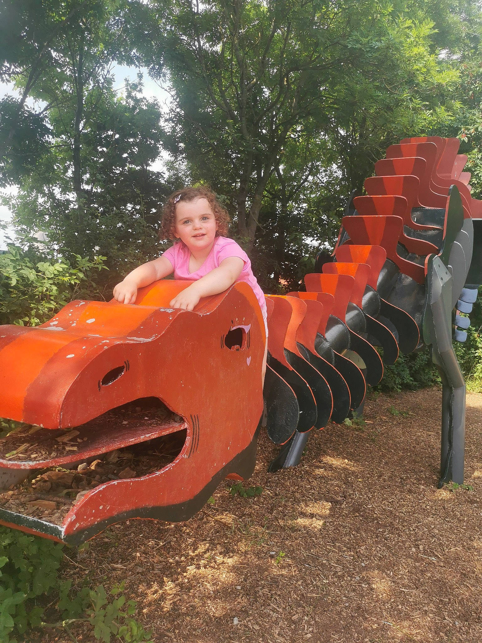 Elizabeth is registered to the contest to win money with this photo: art, chute, city, fun, garden, grass, joy, leisure, outdoor_play_equipment, people_in_nature, person, plant, play, playground, playground_slide, recreation, sitting, smile, soil, toddler