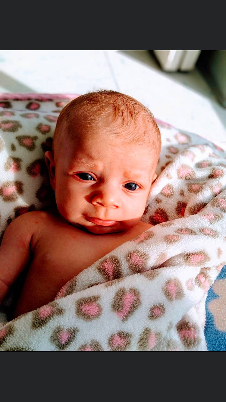 Kaleigha joined the competition — help win amazing prizes! baby, bedding, blanket, cheek, child, eye, face, head, linens, lip, mouth, nose, person, pink, skin, smile, textile, toddler