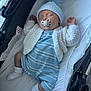 baby, sleeping, pacifier, stroller, blue_outfit, knit_hat, white_socks, cozy, infant, child, cute, peaceful, soft_lighting, indoor, blanket, comfort, newborn, resting, warm_clothing, portrait