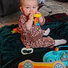 baby, child, toy, blanket, indoor, floor, carpet, couch, person, playing, cute, infant, sitting, clothing, feet, furniture, home, colorful, young, fun
