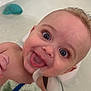 Reese joined the competition — help win amazing prizes! baby, infant, child, bathtub, bath, water, towel, blue_eyes, smiling, tongue_out, eyelashes, hand, head, close_up, bath_toy, rubber_whale, happy, bathroom, skin, portrait