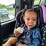 Amia Rose is registered to the contest to win money with this photo: toddler, child, car_seat, denim_jacket, drink, whipped_cream, pink_straw, car_interior, window, seatbelt, pigtails, face, messy_face, happy, person, casual_clothing, vehicle, road, outdoor_view, sitting