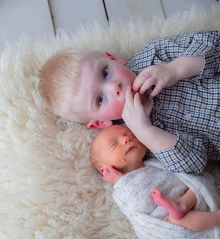 Clint is registered to the contest to win money with this photo: baby, baby_toddler_clothing, cheek, child, comfort, couch, ear, eye, face, facial_expression, finger, happy, iris, lip, nose, pattern, person, skin, sleeve, textile