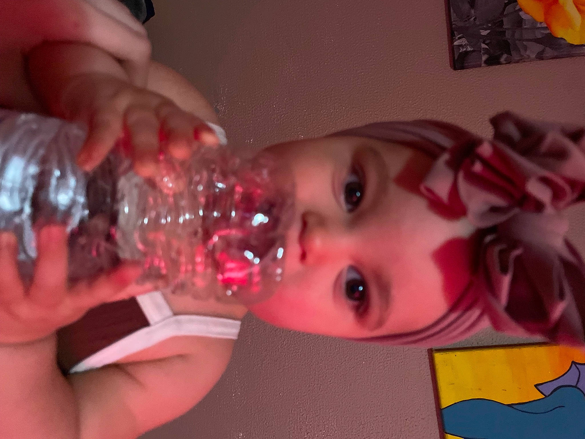 Nyla is registered to the contest to win money with this photo: cheek, child, drink, drinking, drinkware, event, eyelash, finger, fluid, fun, headwear, lip, liquid, mouth, nail, person, pink, plastic_bottle, red, skin