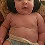 Colton joined the competition — help win amazing prizes! baby, diaper, headphones, cushion, floral, infant, child, chubby, skin, person, indoors, cute, music, listening, face, head, expression, relaxed, seated, plush