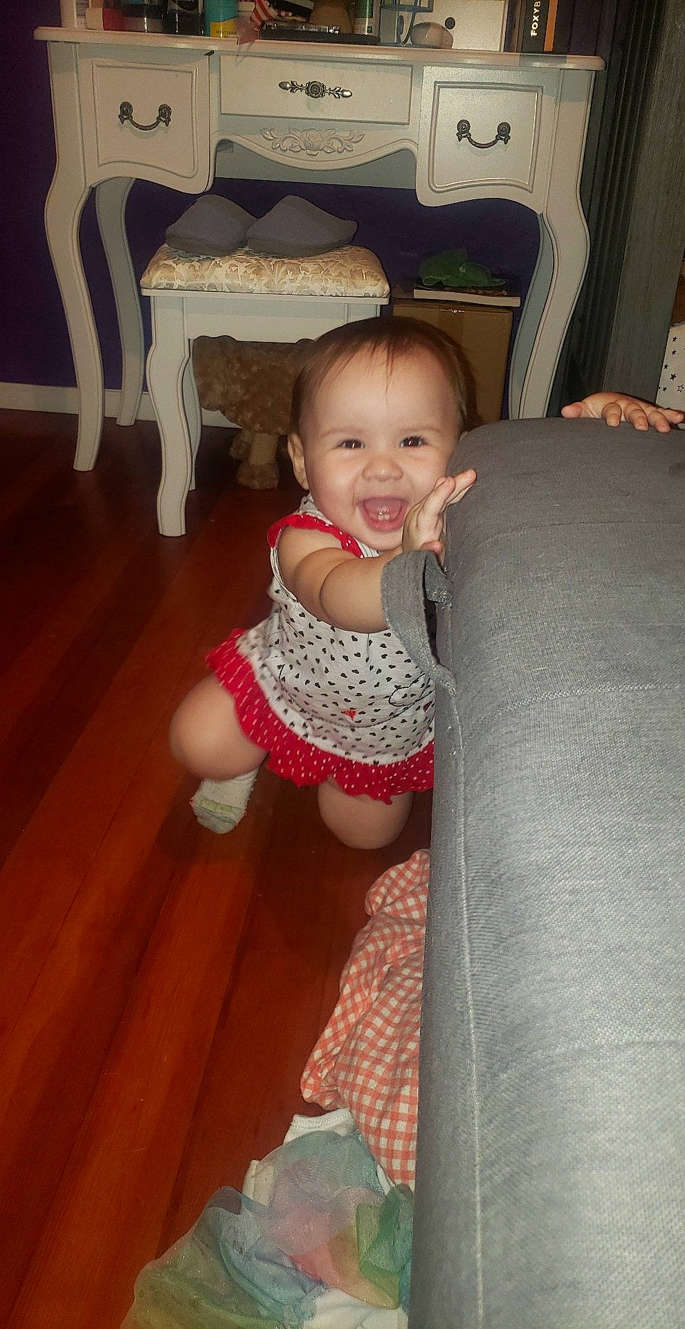 Ophelia is registered to the contest to win money with this photo: baby, cheek, child, eye, floor, iris, leg, person, sitting, skin, smile, standing, toddler, wood