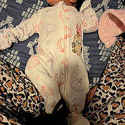 Veronica joined the competition — help win amazing prizes! baby, infant, onesie, sleeping, blanket, patterned_fabric, leopard_print, plush, pink, white_clothing, animal_print, face, head, sleepwear, child, person, soft_texture, cozy, resting, indoor