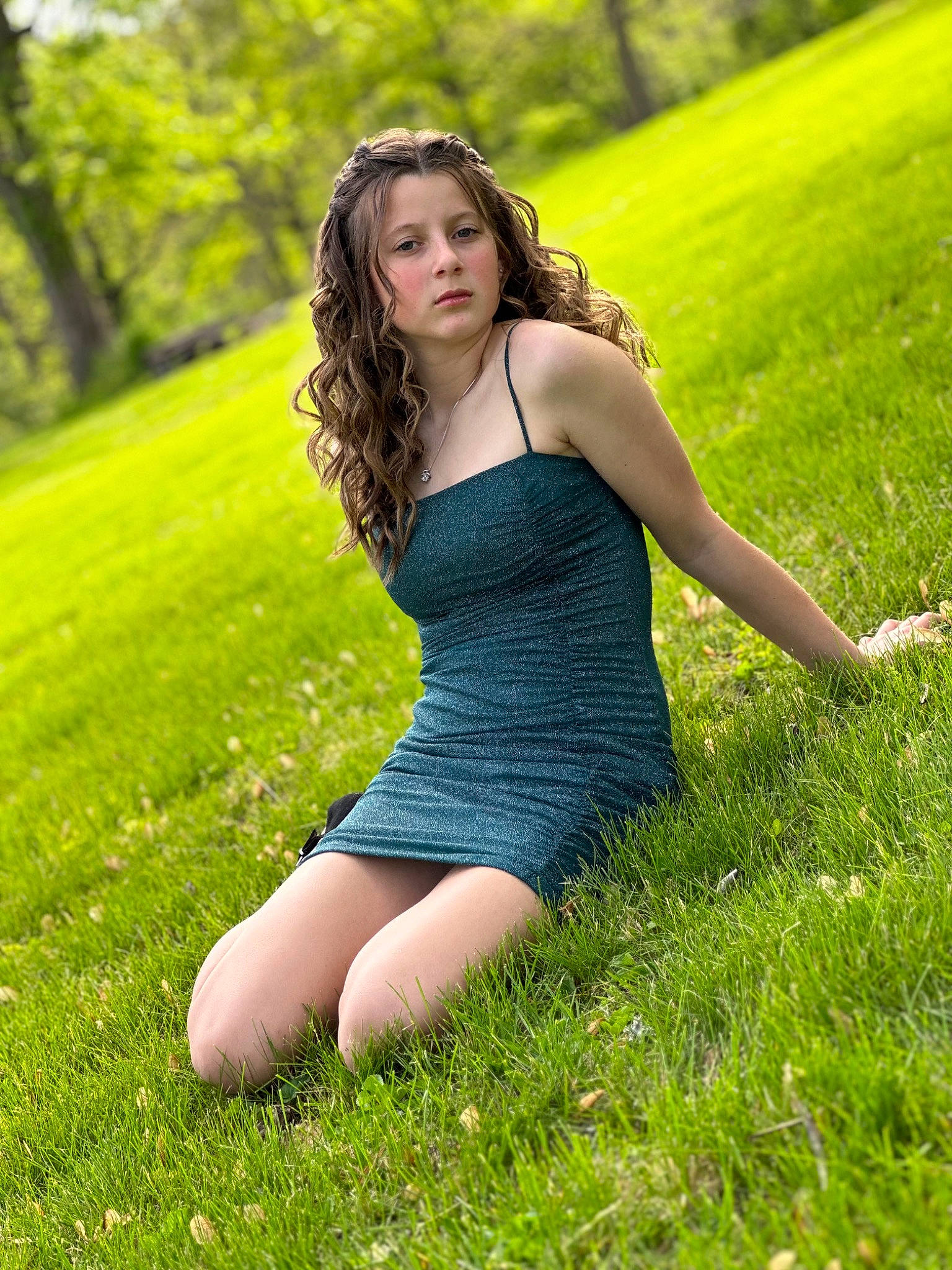 Genesis is registered to the contest to win money with this photo: dress, face, flash_photography, grass, grass_family, grassland, green, hair, happy, human_body, knee, leisure, natural_landscape, people_in_nature, person, plant, summer, sunlight, thigh, tree