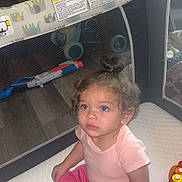 Nova joined the competition — help win amazing prizes! toddler, child, curly_hair, pink_shirt, pink_pants, toy, xylophone, playpen, indoor, home, furniture, wooden_table, chair, floor_mat, cute, sitting, playing, curious, baby, small_bun