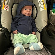 Kason joined the competition — help win amazing prizes! baby, baby_boy, car_seat, child, clothing, comfort, cute, fabric, face, hoodie, indoor, infant, person, portrait, seat, seatbelt, small, socks, warning_label, young_child