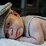 Kason is registered to the contest to win money with this photo: baby, blanket, cap, child, closeup, clothing, cozy, cute, expression, face, hat, indoors, infant, lying_down, newborn, portrait, resting, skin, soft, suspenders