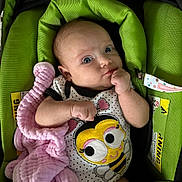 Lilly joined the competition — help win amazing prizes! baby, infant, car_seat, blanket, clothing, green, pink, cute, face, person, child, cute_outfit, indoor, young, holding, expression, soft_toy, comfort, seat, portrait