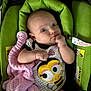 baby, infant, car_seat, blanket, clothing, green, pink, cute, face, person, child, cute_outfit, indoor, young, holding, expression, soft_toy, comfort, seat, portrait