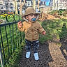 Gabriel a rejoint le concours — aidez-le/la à gagner de superbes lots ! blue_pacifier, buildings, child, curious, cute, daffodils, grass, holding_object, hooded_jacket, jeans, metal_fence, outdoor, park, shadow, sidewalk, spring, toddler, trees, walking, white_sneakers
