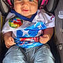 Kamari joined the competition — help win amazing prizes! baby, child, car_seat, headphones, smile, puerto_rico, clothing, headband, portrait, sitting, cute, infant, happy, colorful, casual_wear, jeans, closeup, person, indoors, accessory