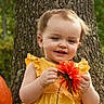 toddler, child, baby, smiling, outdoor, autumn, fall, pumpkin, flower, tree, forest, nature, yellow_dress, red_flower, portrait, sitting, happy, childhood, seasonal, daylight
