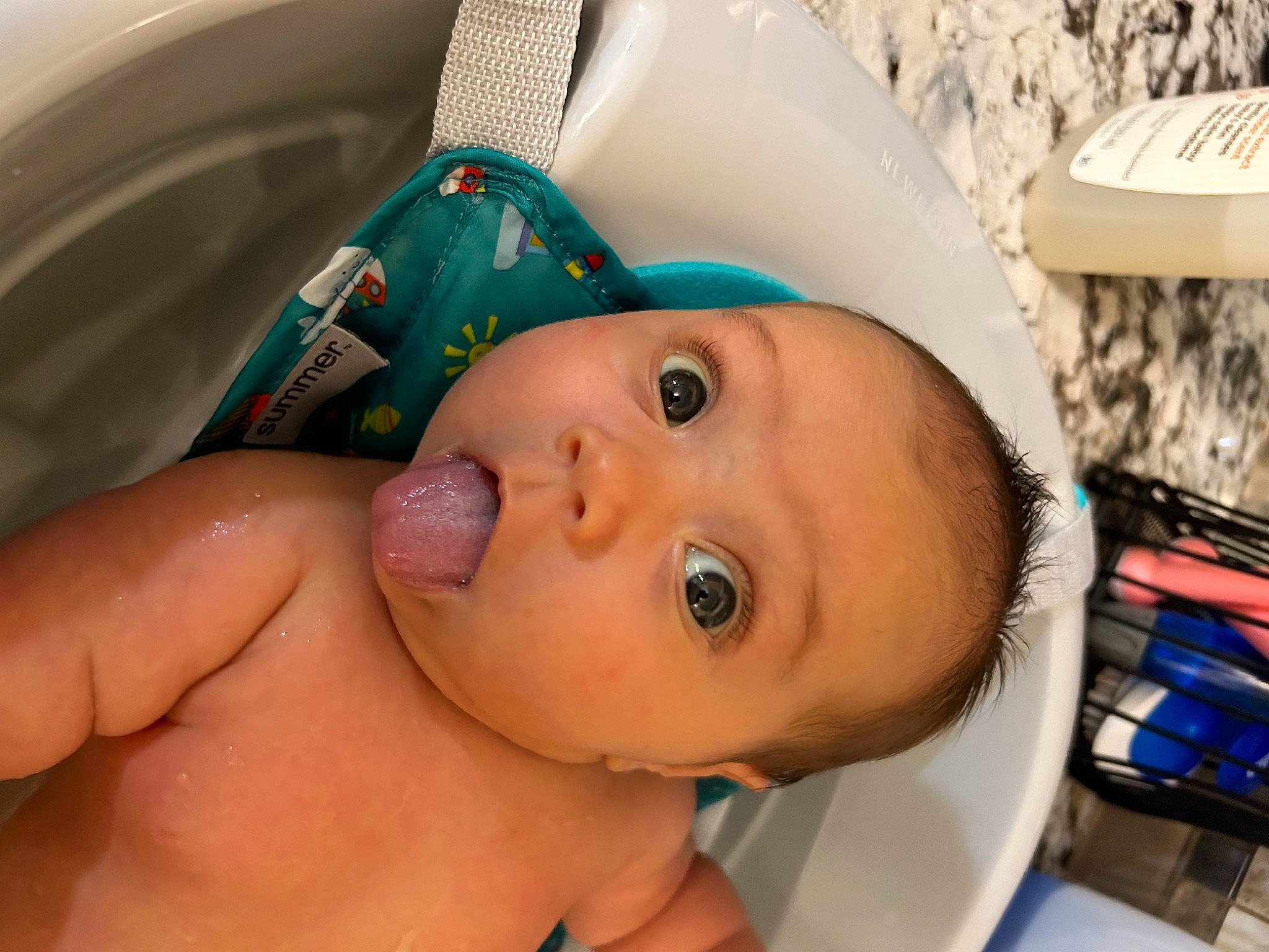 Addie is registered to the contest to win money with this photo: baby, baby_products, bathing, cheek, chest, child, ear, eye, eyelash, face, fashion_accessory, happy, hat, head, headgear, human_body, nail, nose, person, skin