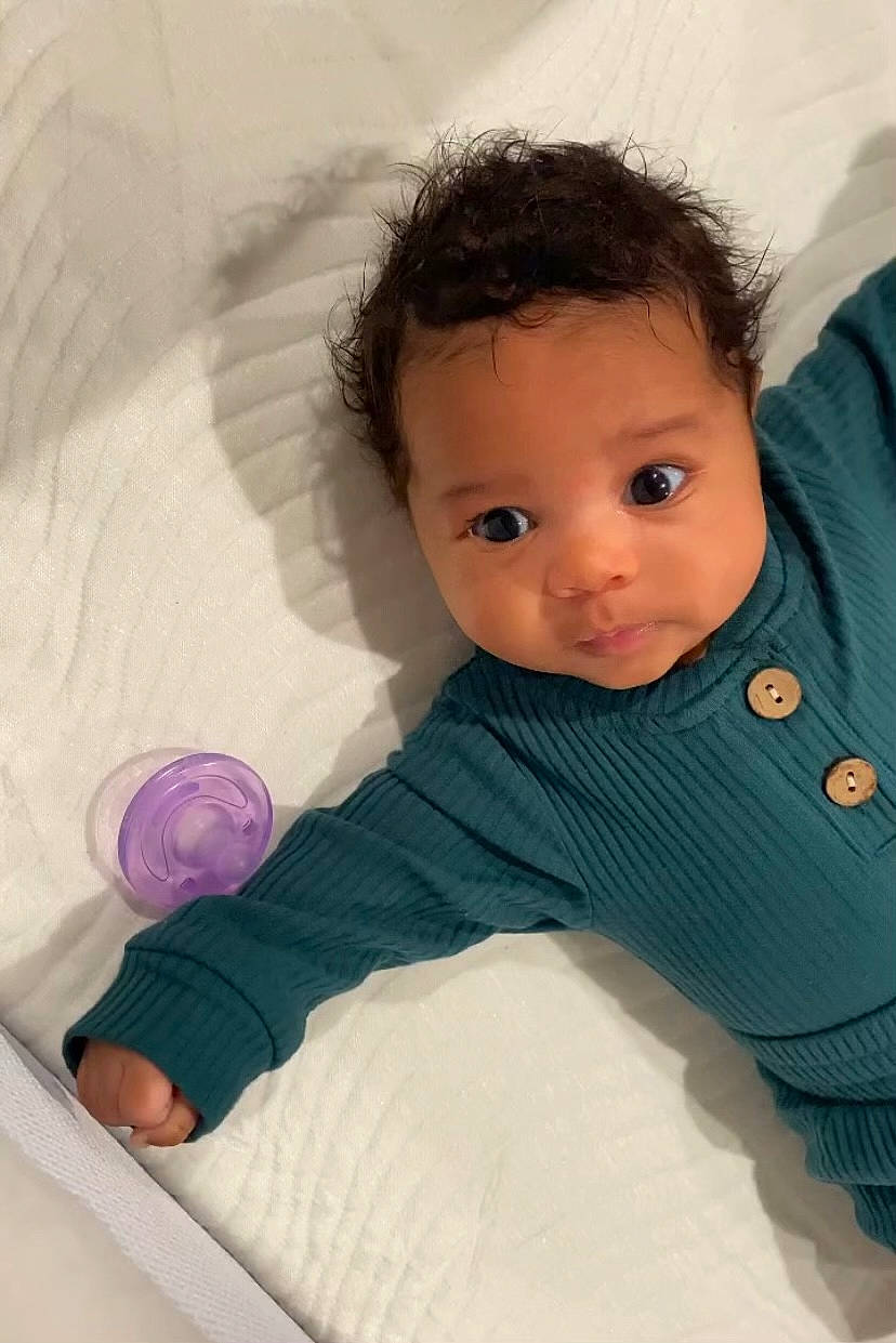 Amia Jay is registered to the contest to win money with this photo: baby, baby_products, baby_toddler_clothing, bedding, cheek, child, circle, comfort, eye, hand, human_body, iris, leg, linens, nose, person, sitting, skin, sleeve, textile