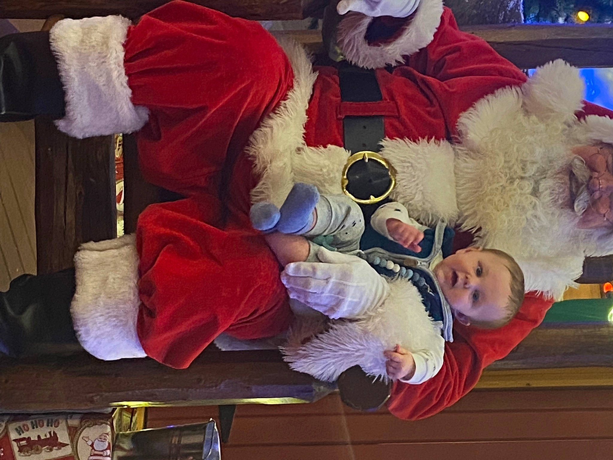 Corbyn is registered to the contest to win money with this photo: baby, baby_toddler_clothing, carmine, child, comfort, event, fun, fur, happy, hat, lap, person, red, room, textile, toddler