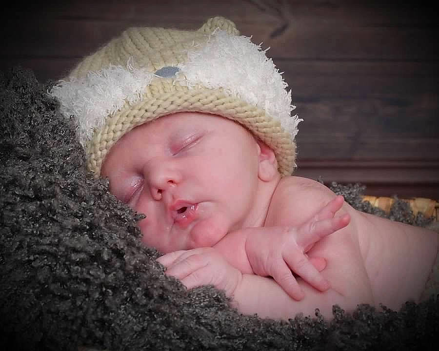 Corbyn is registered to the contest to win money with this photo: baby, baby_sleeping, baby_toddler_clothing, cap, comfort, ear, eye, finger, flash_photography, fur, grass, happy, headpiece, headwear, knit_cap, linens, lip, nose, person, textile
